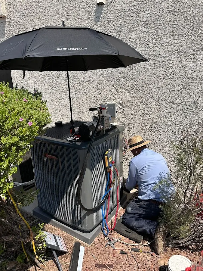 HVAC technician performing outdoor AC maintenance in Homewood